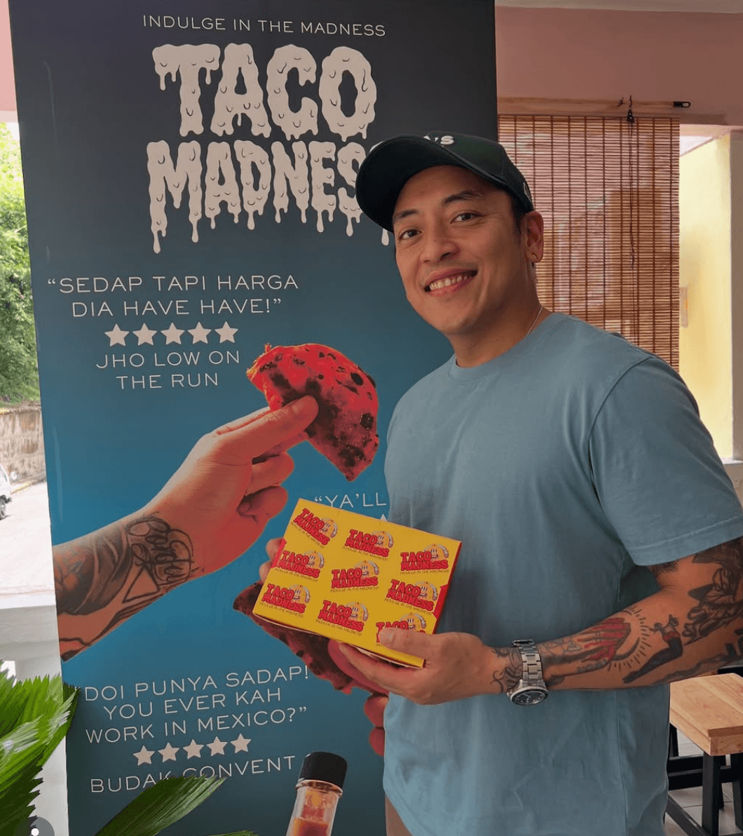 Chef Effardy holding a box of Taco Madness hot sauce